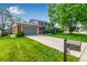 Two-story home featuring a spacious driveway and well-maintained landscaping at 3720 S Willow Cir, Denver, CO 80237