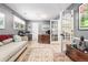 Home office with custom desk, hardwood floors, ample natural light, and stylish decor at 3720 S Willow Cir, Denver, CO 80237