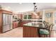 Well-lit kitchen with an island and stainless steel appliances at 3720 S Willow Cir, Denver, CO 80237