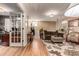 Cozy living room with hardwood floors, stylish furniture, and French door entry at 3720 S Willow Cir, Denver, CO 80237