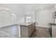 Open kitchen with granite island, stainless appliances, seamlessly connected to the living area at 18009 Dandy Brush Ln, Parker, CO 80134