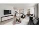Open-concept living space with modern furnishings flows seamlessly into kitchen and dining at 18009 Dandy Brush Ln, Parker, CO 80134