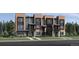 Modern townhome exterior with multi-tone facade, black trim, a covered entry, and professional landscaping at 2545 Josephine Way, Superior, CO 80027