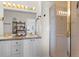 Bright bathroom featuring a double sink vanity and walk-in shower with gold trim at 281 Rockview Dr, Superior, CO 80027