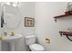 Well-lit half-bath with pedestal sink, decorative shelves and modern fixtures at 281 Rockview Dr, Superior, CO 80027