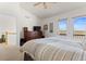 Serene bedroom with a view of the balcony, dark wood dresser, and neutral bedding at 281 Rockview Dr, Superior, CO 80027