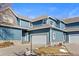 Charming townhome with blue siding, stone accents, and attached two-car garage at 281 Rockview Dr, Superior, CO 80027