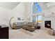 Bright living room featuring high ceilings, a cozy fireplace, and a comfortable sectional sofa at 281 Rockview Dr, Superior, CO 80027