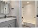 Bathroom features a tiled shower/tub combo and modern fixtures at 1732 Stable View Dr, Castle Pines, CO 80108