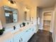 Modern bathroom with double vanity, quartz countertop, and sleek black hardware at 1732 Stable View Dr, Castle Pines, CO 80108