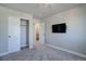 Cozy bedroom with large TV, sliding closet doors and an ensuite bathroom at 1732 Stable View Dr, Castle Pines, CO 80108