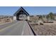 A covered bridge entry to The Canyons at Castle Pines community under a clear blue sky at 1732 Stable View Dr, Castle Pines, CO 80108
