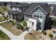 A modern two-story home featuring stone accents, a red door and a well-maintained yard at 1732 Stable View Dr, Castle Pines, CO 80108