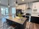 Modern kitchen boasts an island with seating, stainless steel appliances, and stylish pendant lighting at 1732 Stable View Dr, Castle Pines, CO 80108