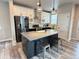 Modern kitchen boasts an island with seating, stainless steel appliances, and stylish two-tone cabinets at 1732 Stable View Dr, Castle Pines, CO 80108