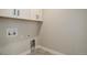 Functional laundry room with overhead cabinets and utility connections at 1732 Stable View Dr, Castle Pines, CO 80108