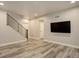 Inviting living room with modern staircase, wood-look floors, and tv at 1732 Stable View Dr, Castle Pines, CO 80108