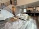 Open-concept living area featuring hardwood floors, modern furnishings, and a seamless flow into the kitchen at 1732 Stable View Dr, Castle Pines, CO 80108