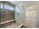 Beautiful walk-in shower featuring sleek gray tile and a frameless glass door at 1732 Stable View Dr, Castle Pines, CO 80108