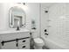 Stylish bathroom with a vanity, modern faucet, an arched mirror, and a combined tub and shower at 3691 S Joplin St, Aurora, CO 80013