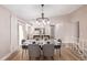 Bright dining room featuring a modern chandelier, open to a newly renovated kitchen and bright backyard at 3691 S Joplin St, Aurora, CO 80013