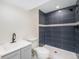 Tastefully updated bathroom with gray vanity and tiled shower at 11510 Otis St, Westminster, CO 80020