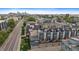 Aerial view of modern townhomes showcasing rooftop patios with outdoor seating areas and scenic cityscape backdrop at 3522 W 17Th Ave, Denver, CO 80204