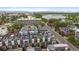 An aerial view of townhomes featuring rooftop decks with outdoor seating, set against a city and lake backdrop at 3522 W 17Th Ave, Denver, CO 80204