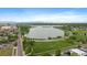 An aerial captures the beauty of Sloan's Lake Park, showcasing tree-lined paths and urban views at 3522 W 17Th Ave, Denver, CO 80204