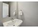 Contemporary bathroom features a sleek pedestal sink, modern faucet, and minimalist design at 3522 W 17Th Ave, Denver, CO 80204