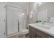 Modern bathroom showcasing a glass-enclosed shower, gray vanity, and neutral tile flooring at 3522 W 17Th Ave, Denver, CO 80204