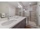 Modern bathroom with double vanity, tiled shower with glass door, and contemporary fixtures at 3522 W 17Th Ave, Denver, CO 80204