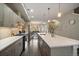 Modern kitchen featuring stainless steel appliances and a large island with bar seating at 3522 W 17Th Ave, Denver, CO 80204