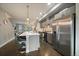 Modern kitchen featuring stainless steel appliances and a large island with bar seating at 3522 W 17Th Ave, Denver, CO 80204