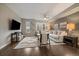 Well-lit living room with hardwood floors, area rug, comfortable seating, and a large window at 3522 W 17Th Ave, Denver, CO 80204