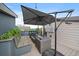 The rooftop deck features an outdoor bar, seating, and an umbrella for relaxation and leisure at 3522 W 17Th Ave, Denver, CO 80204