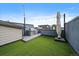 Enjoy outdoor dining and relaxing on the rooftop deck with a built-in grill and synthetic grass at 3522 W 17Th Ave, Denver, CO 80204