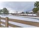 Snowy backyard with wooden fence and patio furniture at 1524 E Weldona Way, Superior, CO 80027