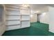 Finished basement with built-in shelving and green carpet at 1524 E Weldona Way, Superior, CO 80027