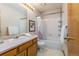 Clean bathroom, shower/tub combo and wood vanity at 1524 E Weldona Way, Superior, CO 80027