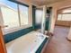 Bathroom with a bathtub, shower, and teal tile at 1524 E Weldona Way, Superior, CO 80027