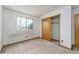 Simple bedroom with wood closet doors and a window at 1524 E Weldona Way, Superior, CO 80027