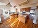 Kitchen with island, wood cabinets, and hardwood floors at 1524 E Weldona Way, Superior, CO 80027