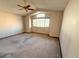 Main bedroom with vaulted ceiling, carpeting, and a large window at 1524 E Weldona Way, Superior, CO 80027