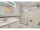 A well-lit bathroom with a combination tub and shower features a modern vanity and updated fixtures at 5300 E Cherry Creek South Dr # 217, Denver, CO 80246