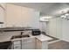 The bright, efficient kitchen features white cabinets, marble countertop and stainless steel appliances at 5300 E Cherry Creek South Dr # 217, Denver, CO 80246