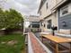 Backyard featuring an outdoor seating area, grill, and well-kept lawn at 12196 Helena St, Commerce City, CO 80603