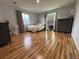 Neutral bedroom with natural light, hardwood floors, and large decorative mirror at 12196 Helena St, Commerce City, CO 80603