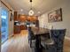 Dining area with modern light fixture, ample seating, and convenient access to the kitchen at 12196 Helena St, Commerce City, CO 80603