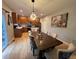 Open-concept dining area with modern lighting, a large table, and easy access to the kitchen at 12196 Helena St, Commerce City, CO 80603
